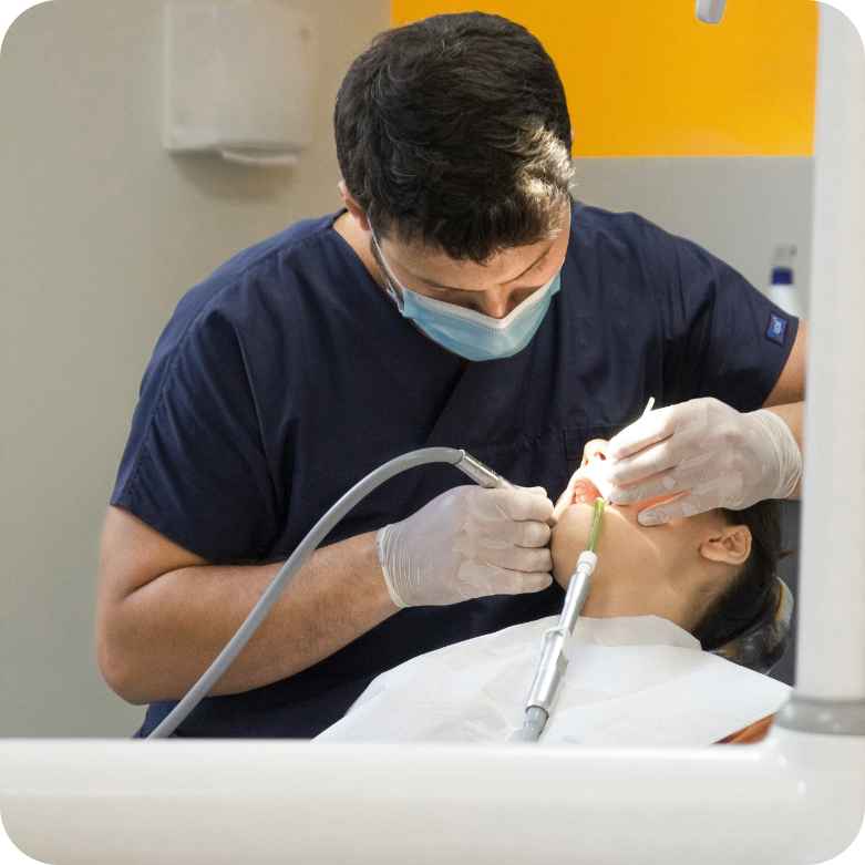 male dentist doing procedure on patient